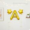 Golden foil balloon combo featuring letter 'A' (16 inch) and two star-shaped balloons (9 inch) for party decoration
