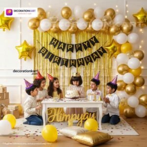 Birthday party setup with DECORATIONkart’s 66 pcs decoration kit featuring a black cardstock “Happy Birthday” banner, golden fringe curtains, metallic balloons in golden, yellow, and white, golden star foils, and DIY accessories.
