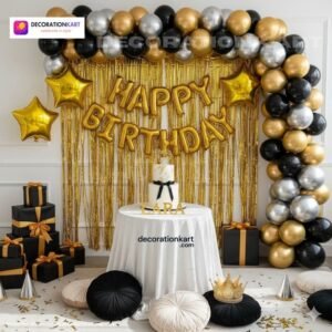 Indian children celebrating a birthday party with DECORATIONkart’s 66 pcs decoration combo set, featuring a golden foil “Happy Birthday” banner, golden fringe curtains, metallic balloons in gold, black, and silver, golden star foil balloons, and DIY accessories.