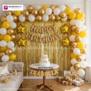 Indian children celebrating a birthday party with DECORATIONkart’s 66 pcs decoration combo set, featuring a golden foil “Happy Birthday” banner, golden fringe curtains, metallic balloons in gold, yellow, and white, golden star foil balloons, and DIY accessories.