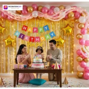 Birthday party setup with DECORATIONkart’s 66 pcs decoration kit featuring a multicolor cardstock “Happy Birthday” banner, golden fringe curtains, metallic balloons in golden, pink, and white, golden star foils, and DIY accessories.
