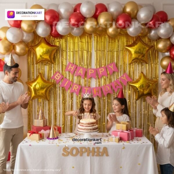 Birthday party setup with DECORATIONkart’s 66 pcs decoration kit featuring a pink cardstock “Happy Birthday” banner, golden fringe curtains, metallic balloons in golden, red, and white, golden star foils, and DIY accessories.