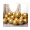 Glossy golden chrome latex balloons floating in a luxurious party setup with elegant lighting and royal décor accents.