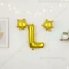 Golden foil balloon combo featuring letter 'L' (16 inch) and two star-shaped balloons (9 inch) for party decoration