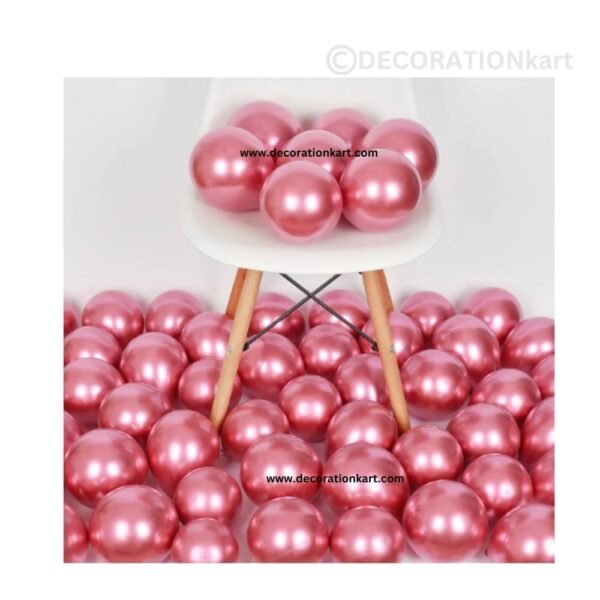 Glossy pink chrome latex balloons floating in a dreamy party setup with floral accents and soft lighting.