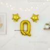 Golden foil balloon combo featuring letter 'Q' (16 inch) and two star-shaped balloons (9 inch) for party decoration