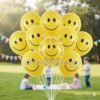 Bright yellow latex balloons printed with smiley faces, floating in a fun and festive kids party setup.