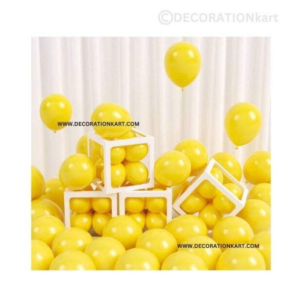 Glossy yellow chrome latex balloons floating in a luxurious party setup with elegant lighting.