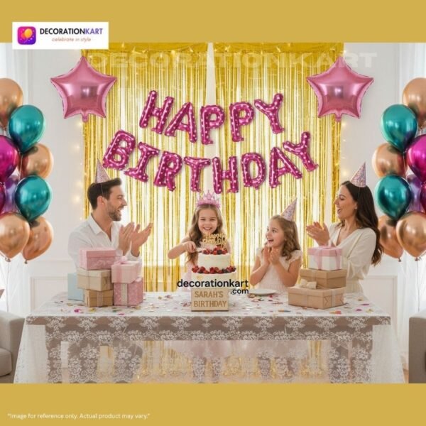 Indian children celebrating a birthday party with a pink polka-dot “Happy Birthday” balloon banner, colorful metallic balloons, star foil balloons, and golden fringe curtain backdrop.