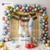 Anniversary party setup with DECORATIONkart’s 69 pcs decoration kit featuring a black cardstock “Happy Anniversary” banner, golden fringe curtains, multicolor metallic balloons, golden and red heart foils, and DIY accessories.