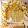 Haldi ceremony setup with DECORATIONkart’s 58 pcs decoration kit featuring a golden foil “Haldi” banner, golden fringe curtains, metallic balloons in golden, white, and yellow, multicolor star foils, and DIY accessories.