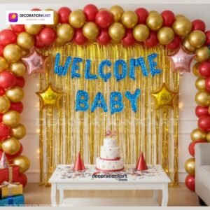 Welcome baby party setup with DECORATIONkart’s 64 pcs decoration kit featuring a blue dotted foil “Welcome Baby” banner, golden fringe curtains, metallic balloons in golden, yellow, and red, multicolor star foils, and DIY accessories.