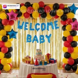 Welcome baby party setup with DECORATIONkart’s 64 pcs decoration kit featuring a blue dotted foil “Welcome Baby” banner, golden fringe curtains, metallic balloons in yellow, red, and black, multicolor star foils, and DIY accessories.