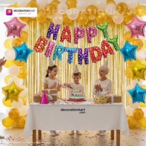Indian children celebrating a birthday party with DECORATIONkart’s 66 pcs decoration combo set, featuring a multicolor foil “Happy Birthday” banner, golden fringe curtains, metallic balloons in gold, yellow, and white, colorful star foil balloons, and DIY accessories.
