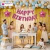 Indian children celebrating a birthday party with DECORATIONkart’s 66 pcs decoration combo set, featuring a pink foil “Happy Birthday” banner, golden fringe curtains, metallic balloons in gold, blue, and white, multicolor star foil balloons, and DIY accessories.