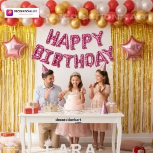 Indian children celebrating a birthday party with DECORATIONkart’s 66 pcs decoration combo set, featuring a pink foil “Happy Birthday” banner, golden fringe curtains, metallic balloons in gold, red, and white, multicolor star foil balloons, and DIY accessories