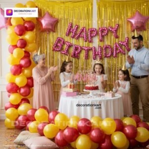 Indian children celebrating a birthday party with DECORATIONkart’s 66 pcs decoration combo set, featuring a pink foil “Happy Birthday” banner, golden fringe curtains, metallic balloons in gold, yellow, and red, pink star foil balloons, and DIY accessories.
