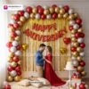 Anniversary party setup with DECORATIONkart’s 69 pcs decoration kit featuring a red foil “Happy Anniversary” banner, golden fringe curtains, metallic balloons in golden, red, and white, golden and red heart foils, and DIY accessories.