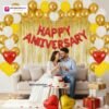 Anniversary party setup with DECORATIONkart’s 69 pcs decoration kit featuring a red foil “Happy Anniversary” banner, golden fringe curtains, metallic balloons in golden, white, and yellow, golden and red heart foils, and DIY accessories.