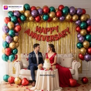 Anniversary party setup with DECORATIONkart’s 69 pcs decoration kit featuring a red foil “Happy Anniversary” banner, golden fringe curtains, multicolor metallic balloons, golden and red heart foils, and DIY accessories.